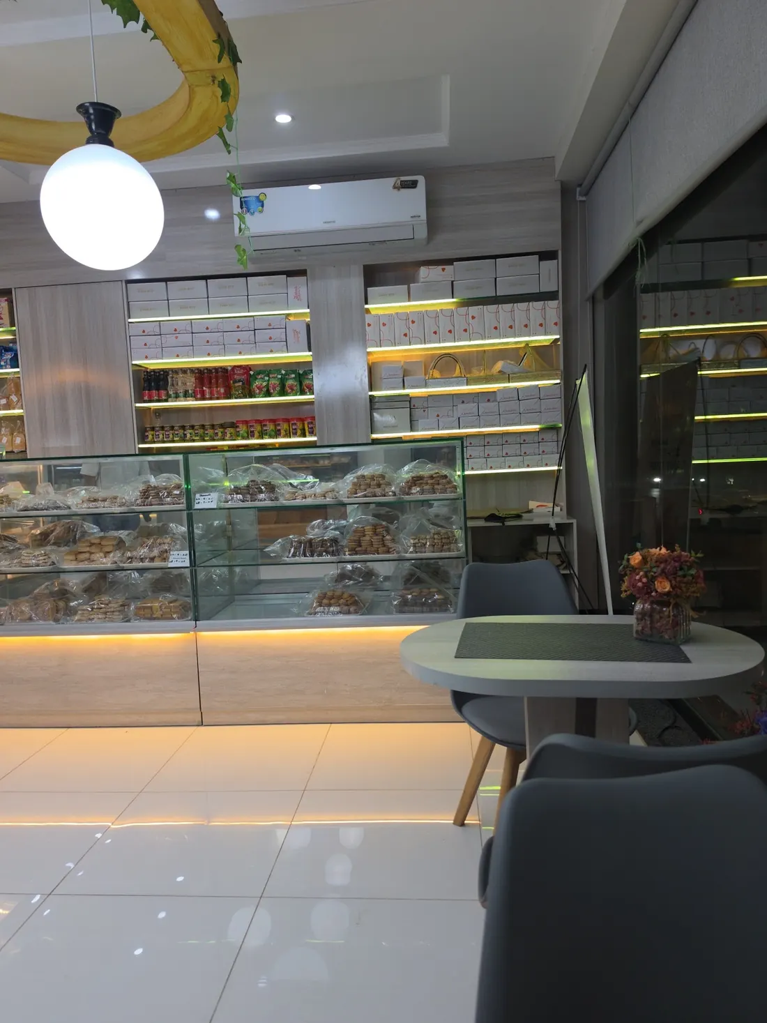 Inside Sabah Bakers: glass counters and shelves of boxed bakes